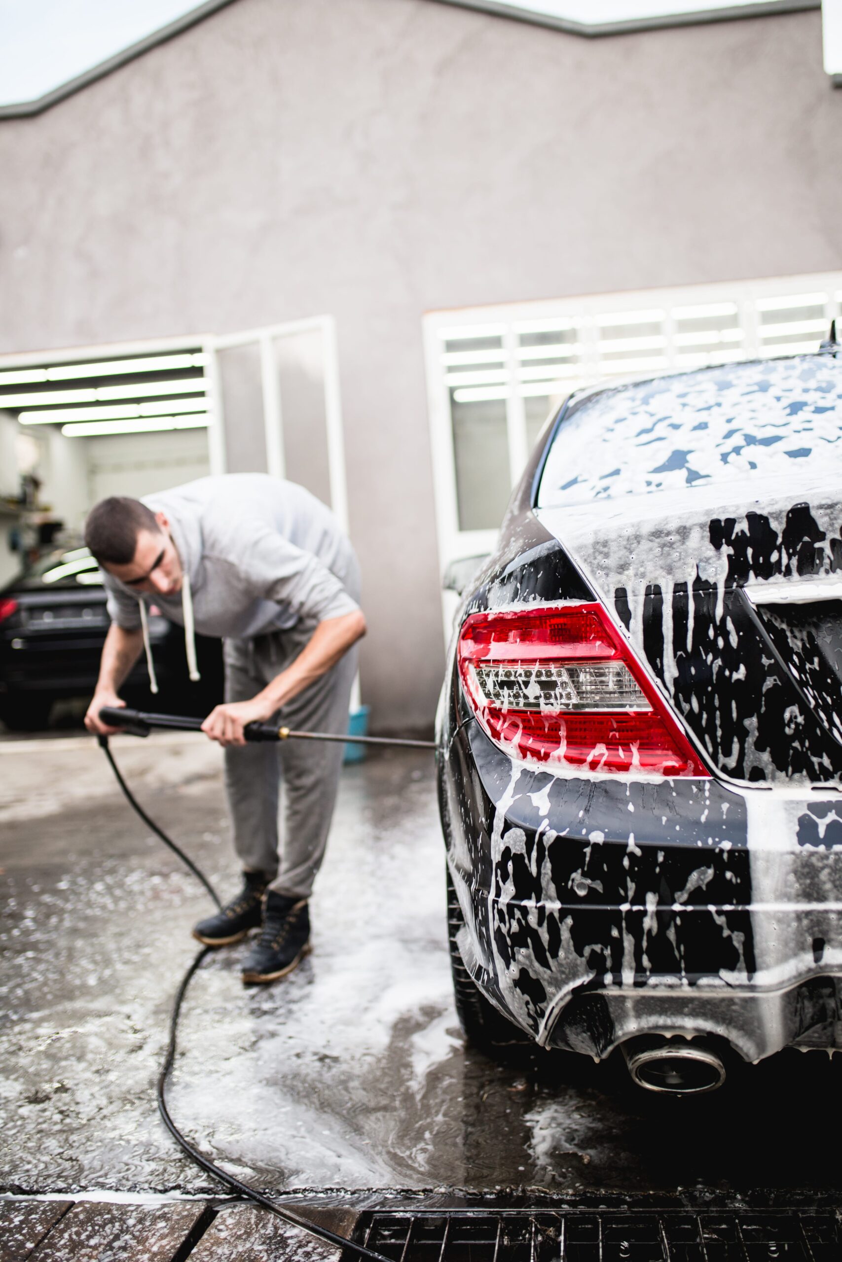 car-washing-cleaning-car-using-high-pressure-water-min