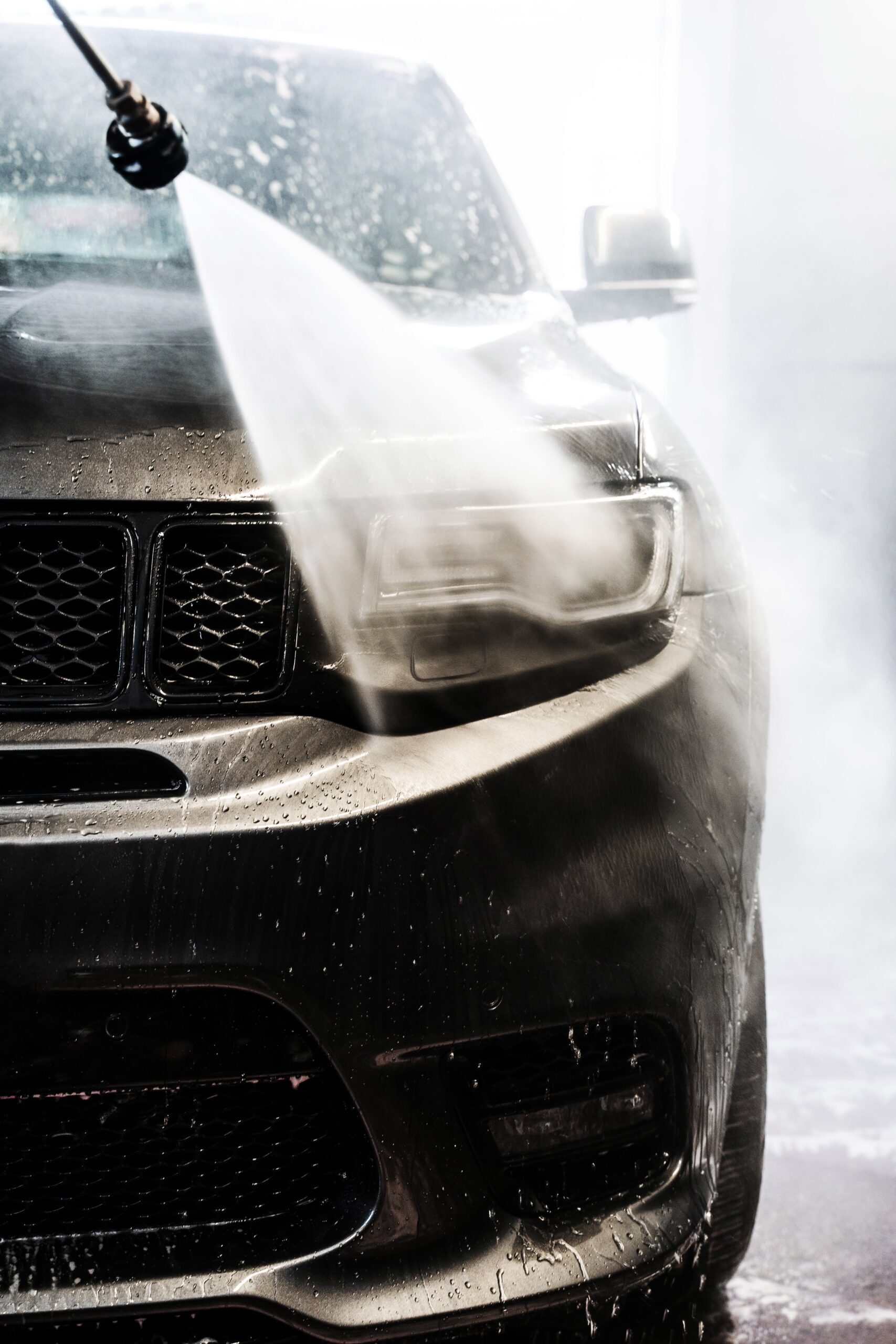 washing-off-foam-from-headlight-using-highpressure-washer-jet-final-rinse-ensures-thorough-cleaning-removes-any-remaining-soap-min